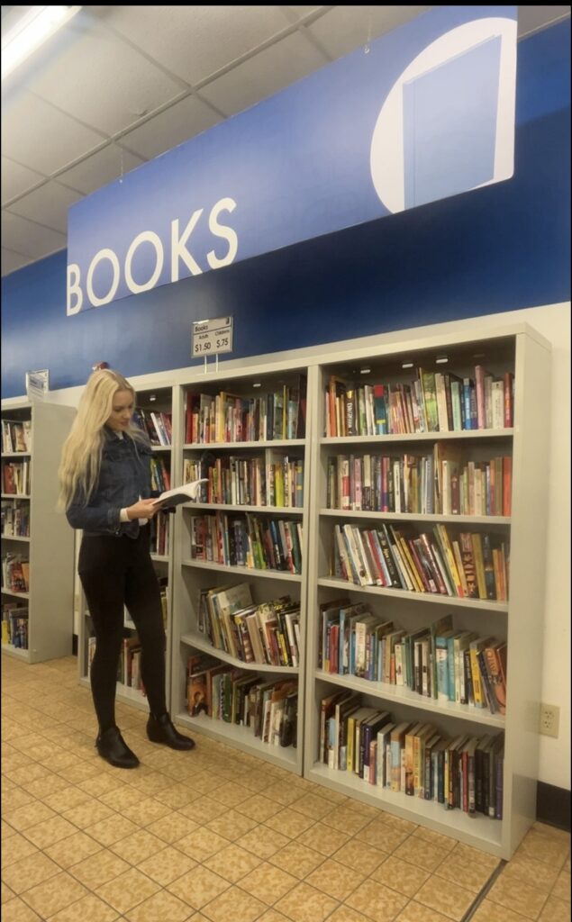 Julie Holiday looking at books.