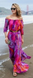 Woman in a multicolored beach wedding guest dress.