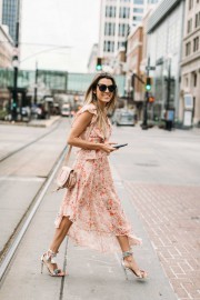 Woman in a casual flowy dress and heels.